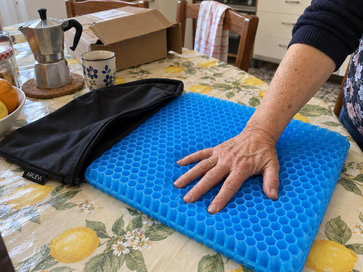 Mano che preme sul cuscino in gel a nido d'ape Arlevi sul tavolo della cucina